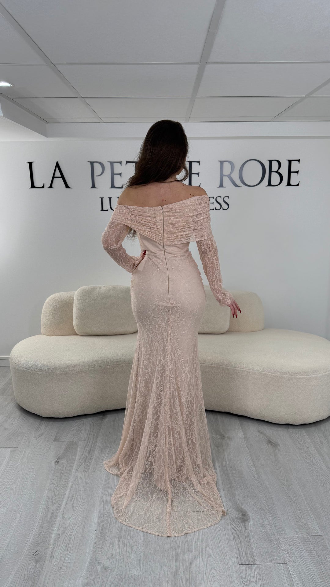 Robe de soirée rose élégante avec col bardot et manches longues en dentelle. Coupe ajustée sans fente, idéale pour une allure chic et féminine.