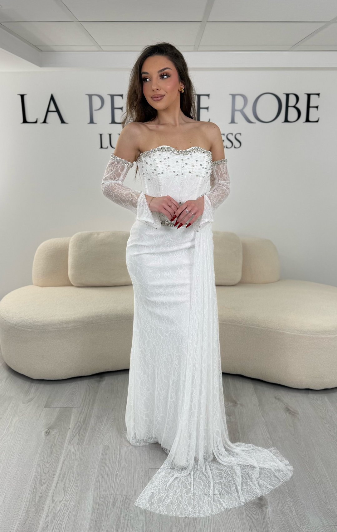 Robe de mariée blanche avec col bustier et manches amovibles en dentelle. Coupe ajustée sans fente, élégante et idéale pour un mariage chic.