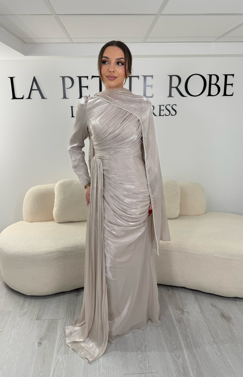 Robe de soirée modeste beige avec manches longues et écharpe assortie. Coupe fluide sans fente, idéale pour une allure élégante et raffinée.