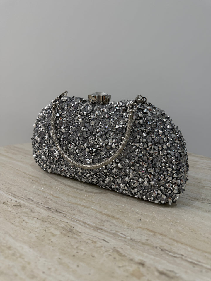 Pochette de soirée argentée strassée élégante avec anse main et bandoulière chaîne. Idéale pour mariage, soirée et cérémonie chic.