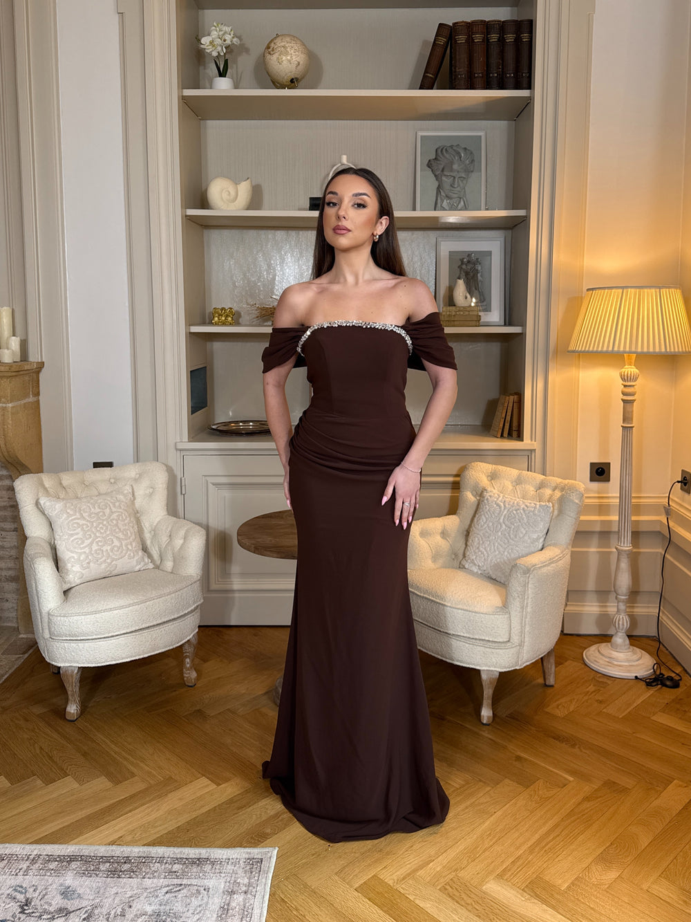 Robe de soirée marron élégante au col bateau, coupe longue et fluide sans fente. Une tenue chic et raffinée pour vos soirées.