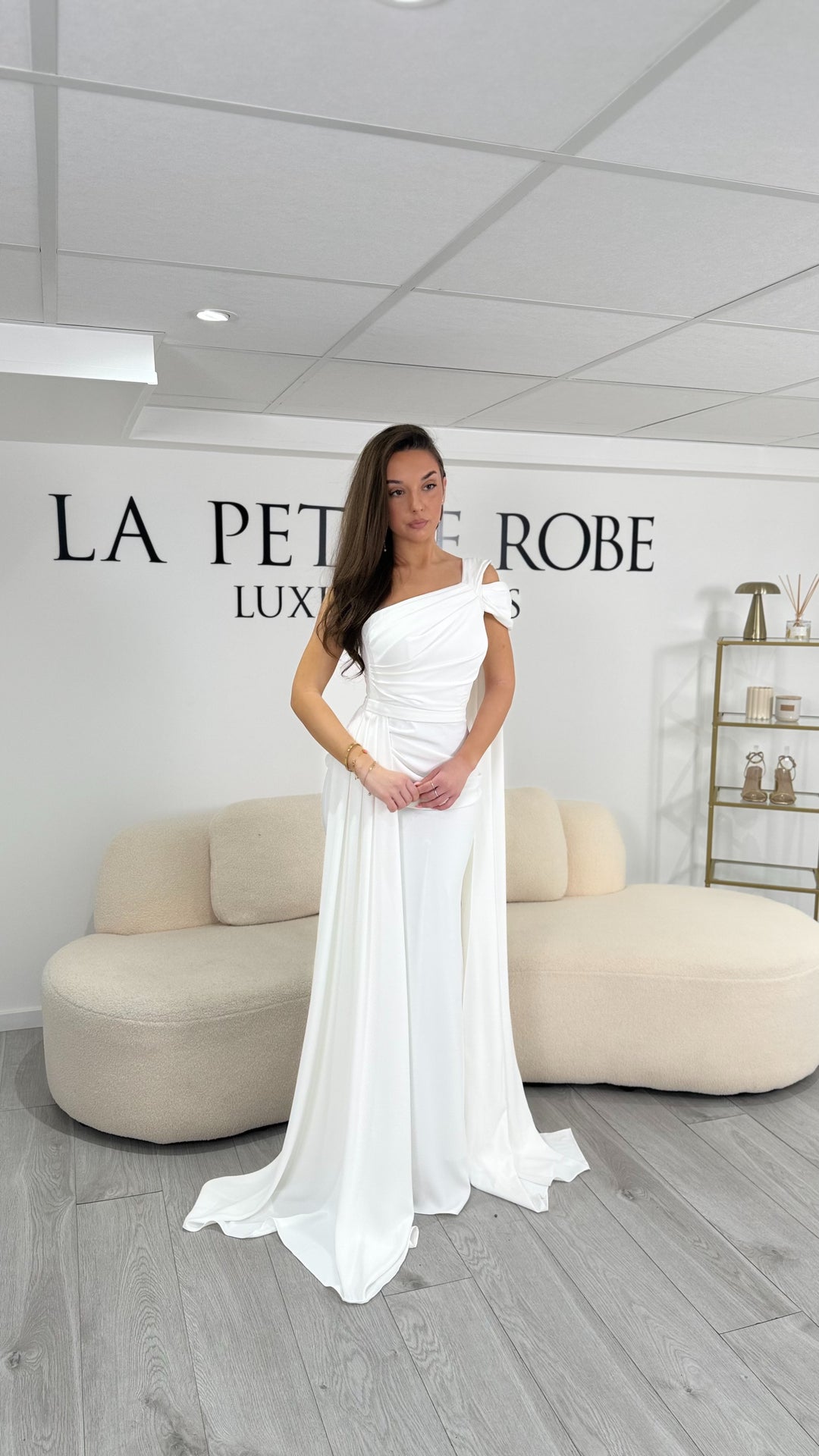 Robe de mariée blanche élégante, longue et fluide, sans manches et sans fente. Une tenue raffinée et intemporelle pour un mariage chic et élégant.