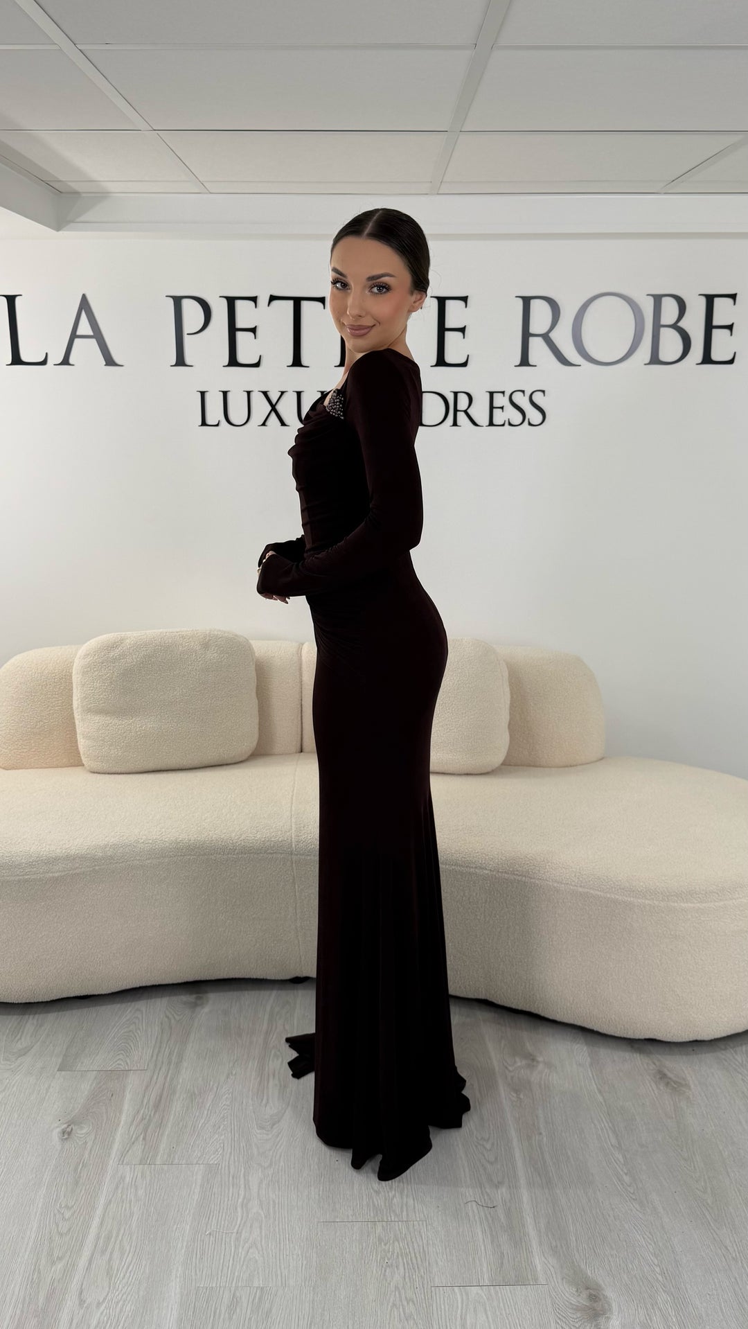 Robe de soirée marron longue avec col bateau drapé et manches longues. Robe élégante sans fente parfaite pour soirée ou gala.