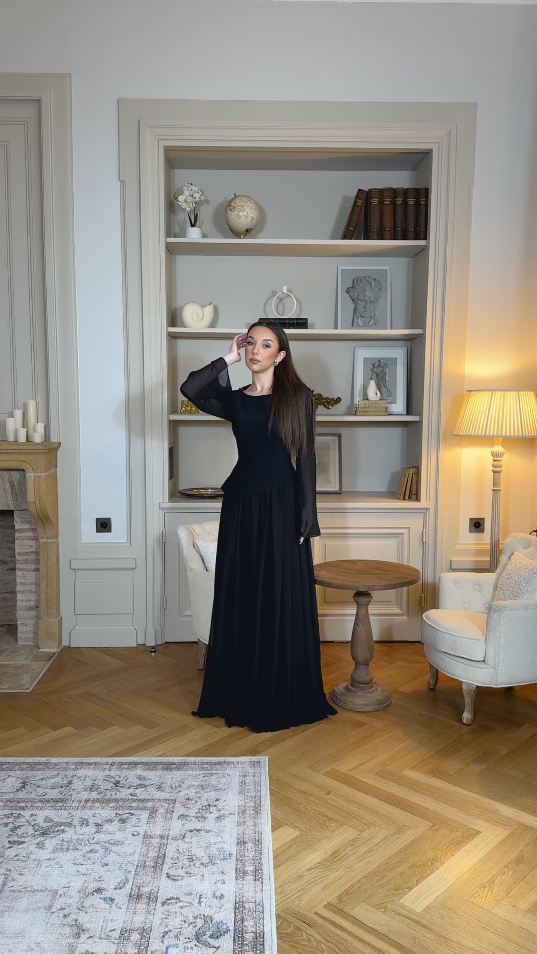 Robe de soirée noir élégante avec col rond et manches longues, coupe fluide sans fente. Une robe chic et intemporelle pour vos soirées.